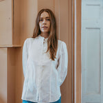White linen shirt with pintucked bib front, lace trim and puff sleeves, styled with blue jeans — Ada White Linen Shirt by Sorority