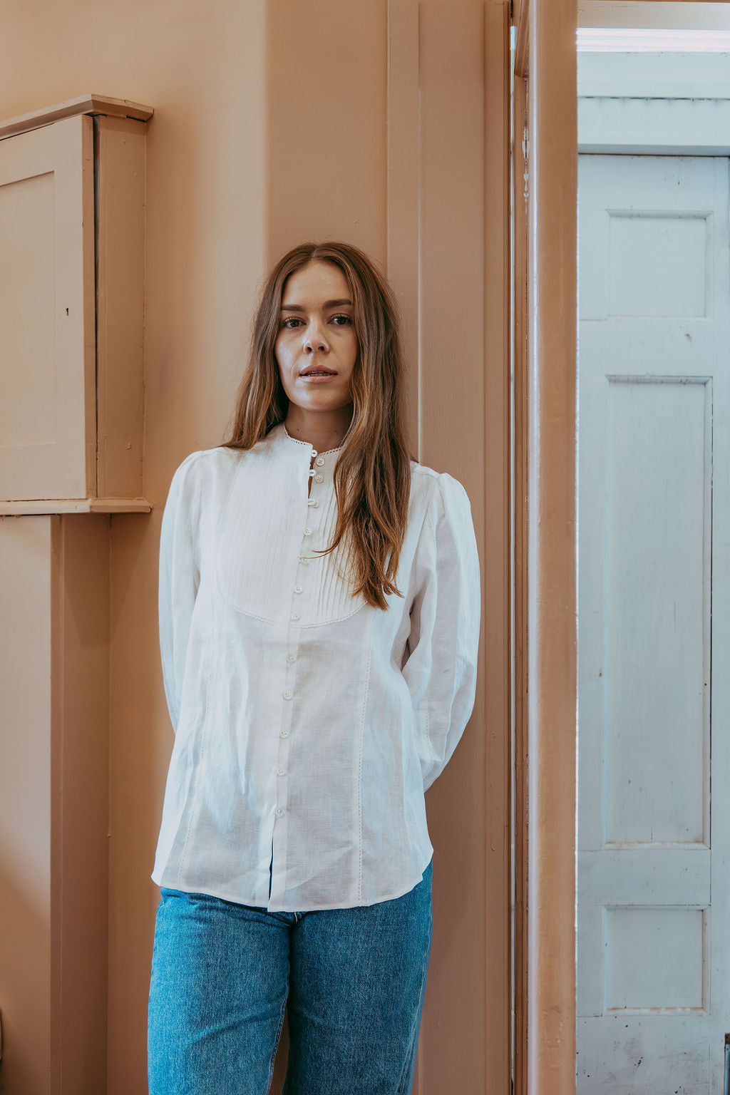 White linen shirt with pintucked bib front, lace trim and puff sleeves, styled with blue jeans — Ada White Linen Shirt by Sorority