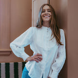 White linen shirt with pintucked bib front, lace trim and puff sleeves, styled with blue jeans — Ada White Linen Shirt by Sorority