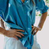 Person wearing a blue shirt with a blurred background