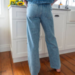 rear view of Patchwork detail denim straight leg jeans with large pockets light colour 