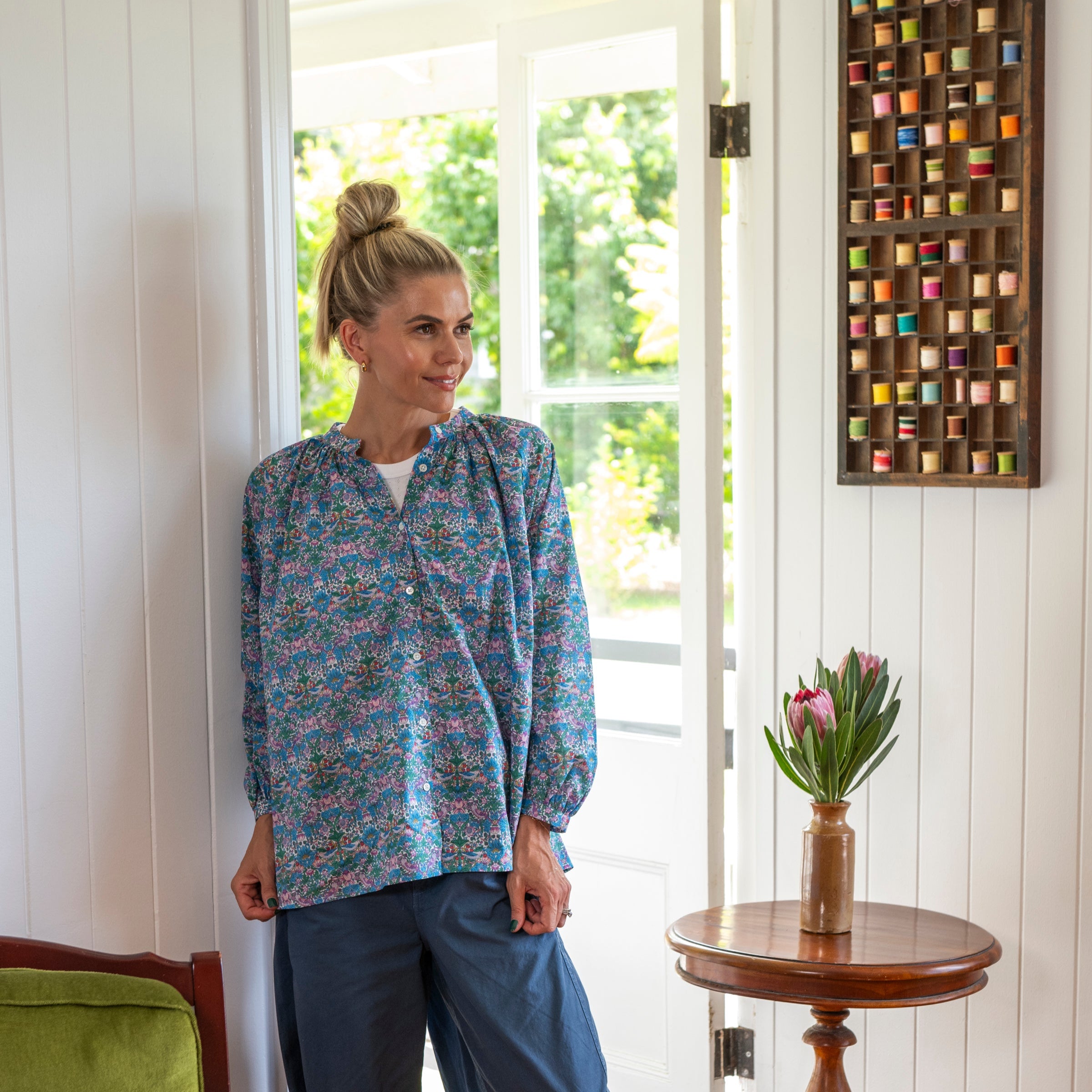 Worn relaxed liberty fabrics cotton shirt with multicolours and classically styled with blue pants
