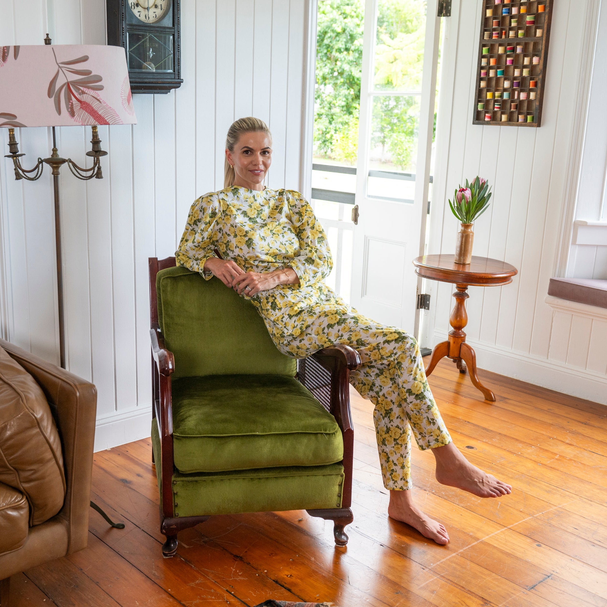 Yellow Rose Floral Cotton Fabric by Liberty. Belted Pants with Matching Floral top in a puff sleeve style sitting down. Tapered at bottom