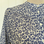 Close-up of a fabric with blue floral pattern on beige background