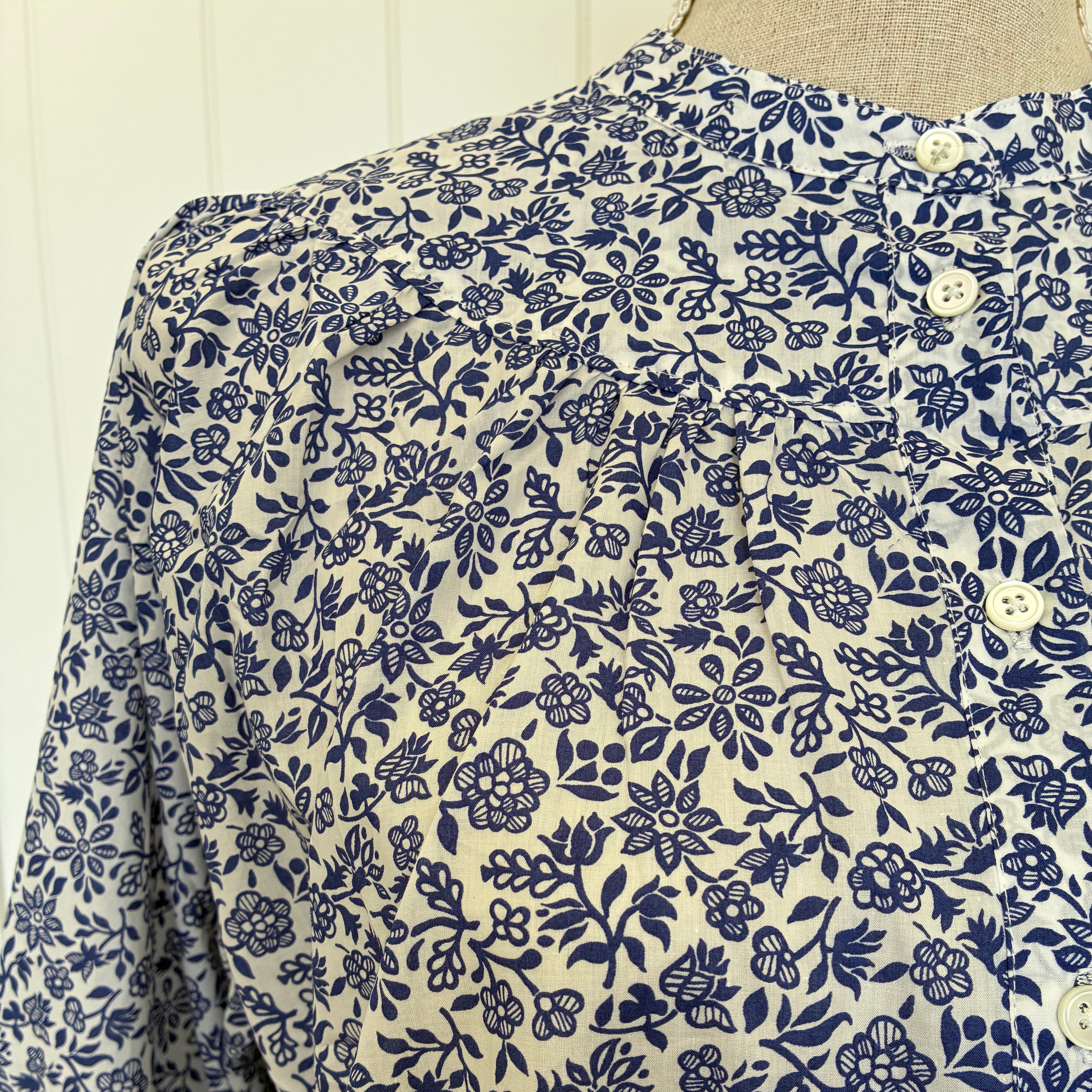 Close-up of a fabric with blue floral pattern on beige background