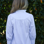 Model wearing Iris cotton blouse, back view