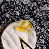 Cheesecake with a slice removed on a floral-patterned surface