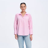 Woman wearing a pink striped shirt and light blue jeans on a white background