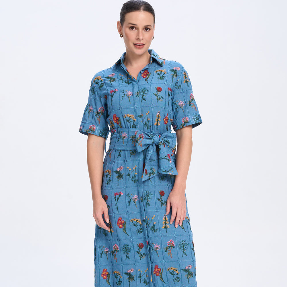 Woman wearing a blue floral dress on a white background