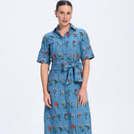 Woman wearing a blue floral dress on a white background