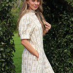 model wearing Clara linen dress, side view with hand in pocket
