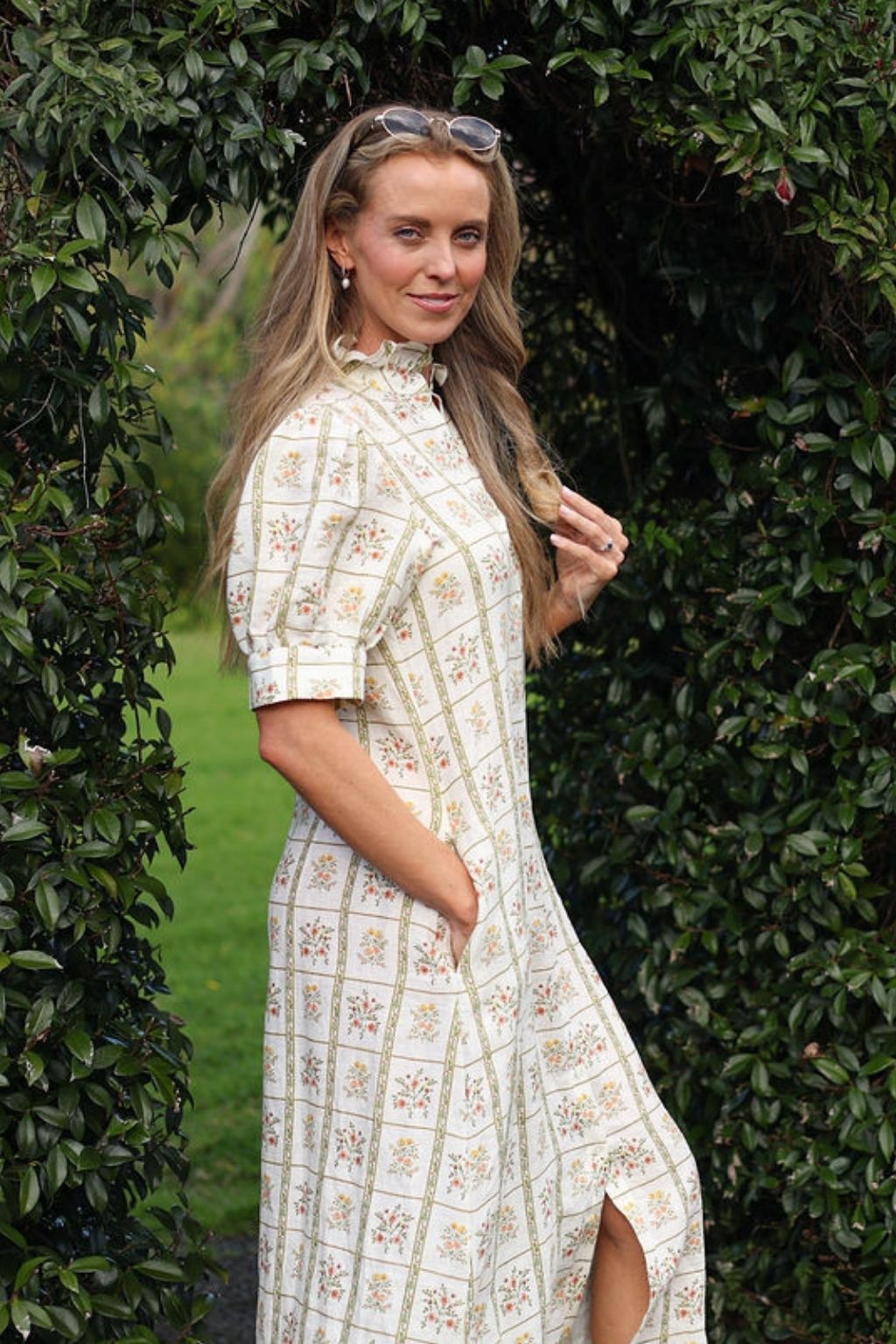 model wearing Clara linen dress, side view with hand in pocket
