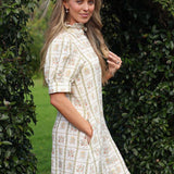 model wearing Clara linen dress, side view with hand in pocket