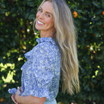 model wearing Nina shirt, cotton, in Wharfdale Liberty print, side view