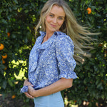 model wearing Nina shirt, cotton, in Wharfdale Liberty print, three quarter right side view