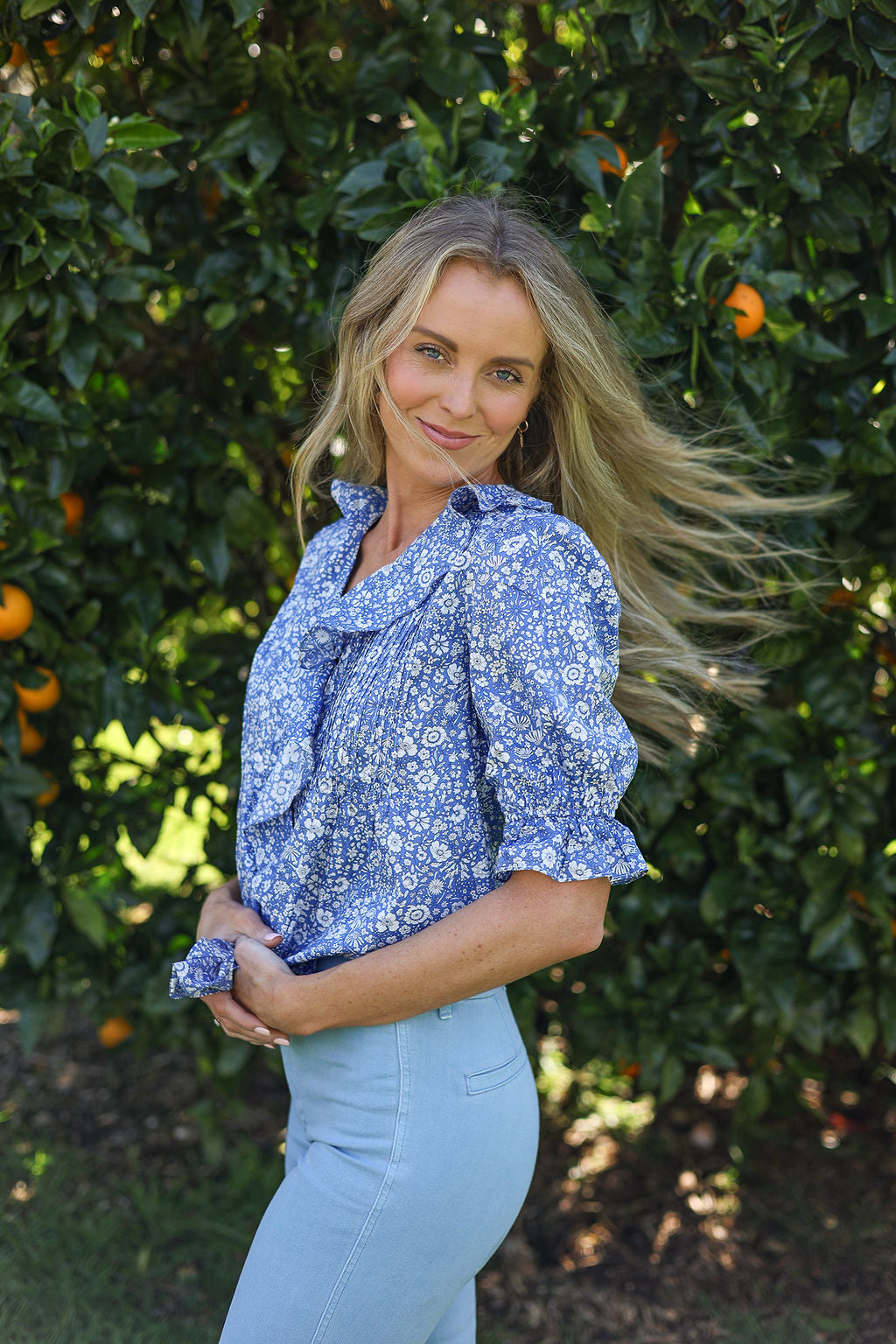 model wearing Nina shirt, cotton, in Wharfdale Liberty print, three quarter right side view