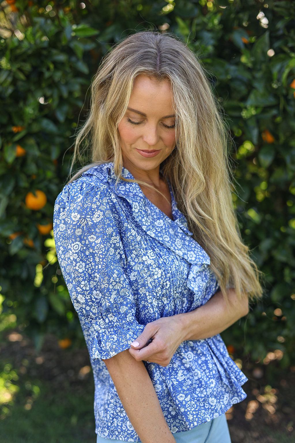 model wearing Nina shirt, cotton, in Wharfdale Liberty print, three quarter view