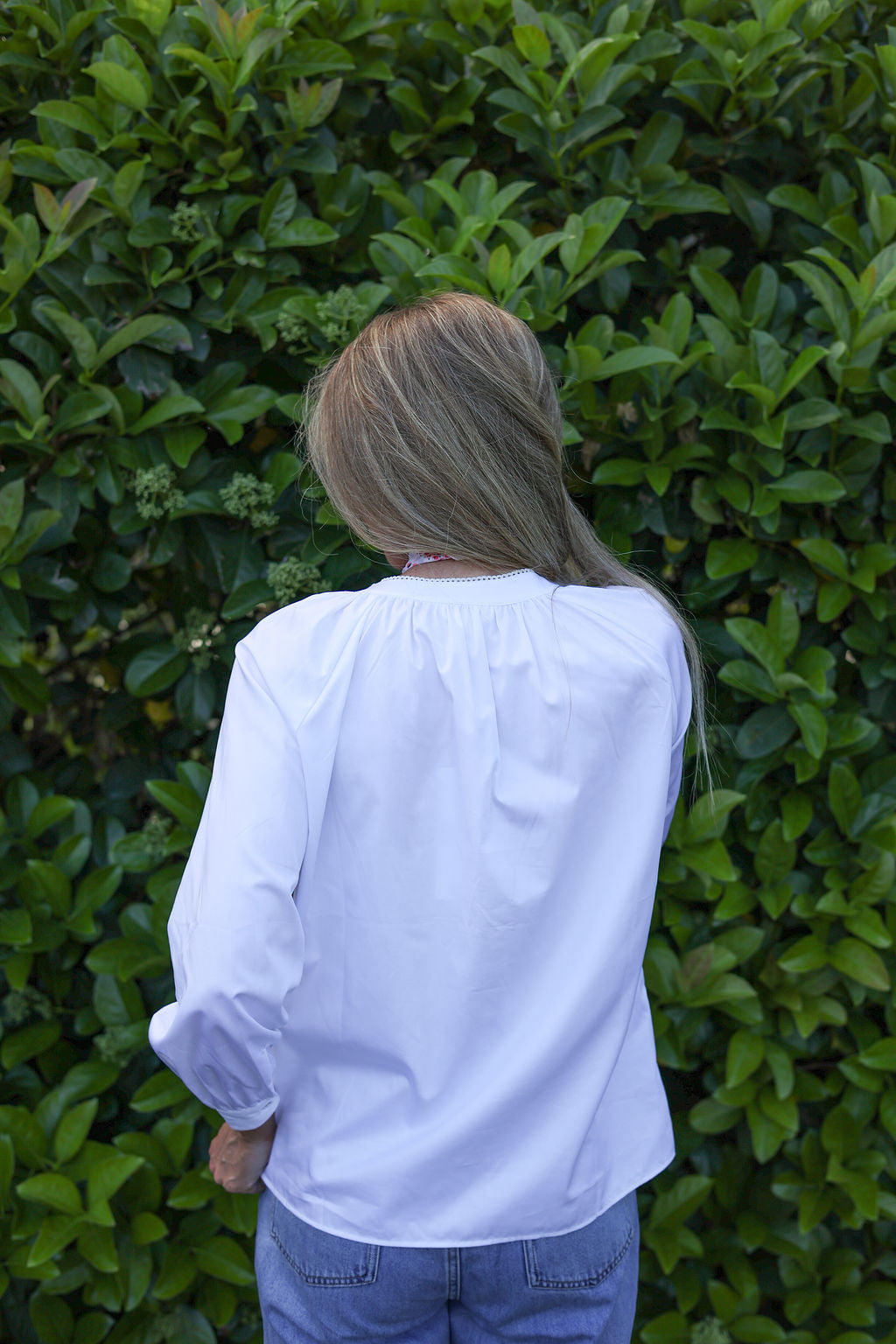 model wearing Valerie white cotton shirt with lace trim, back view