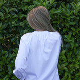 model wearing Valerie white cotton shirt with lace trim, back view